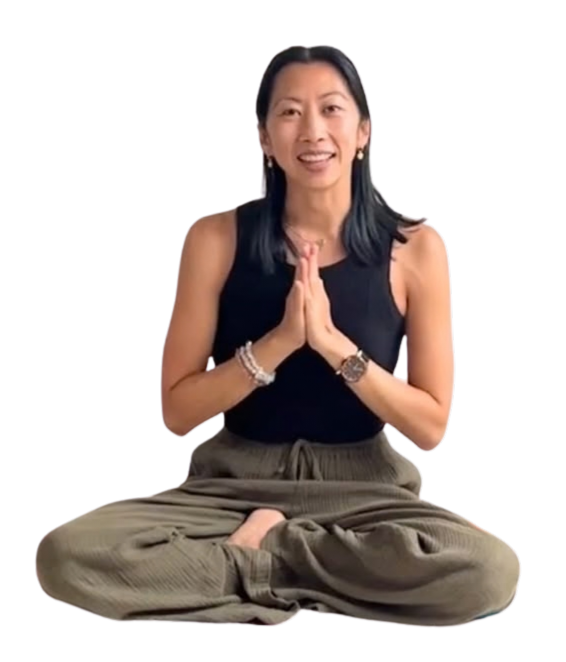Catherine seated in a yoga pose