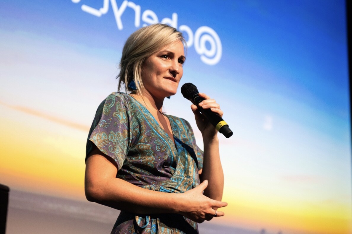 Chez Tansey speaking on stage