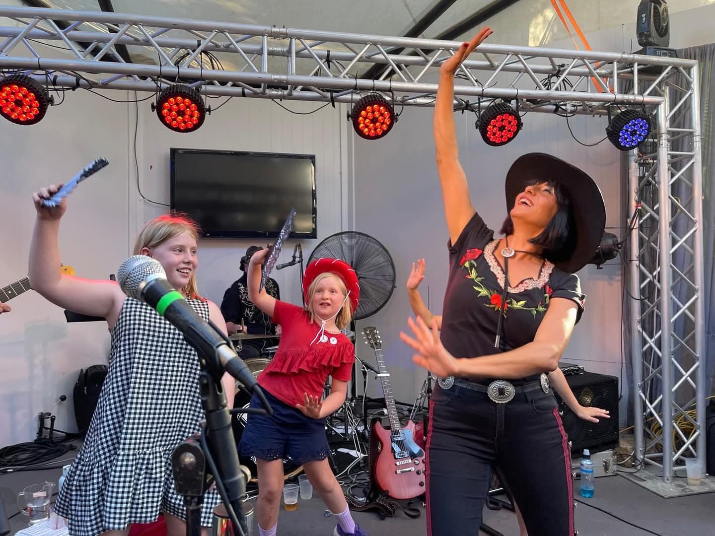 Mel moving on stage with young performers